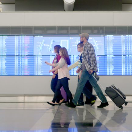 Family walking through airport